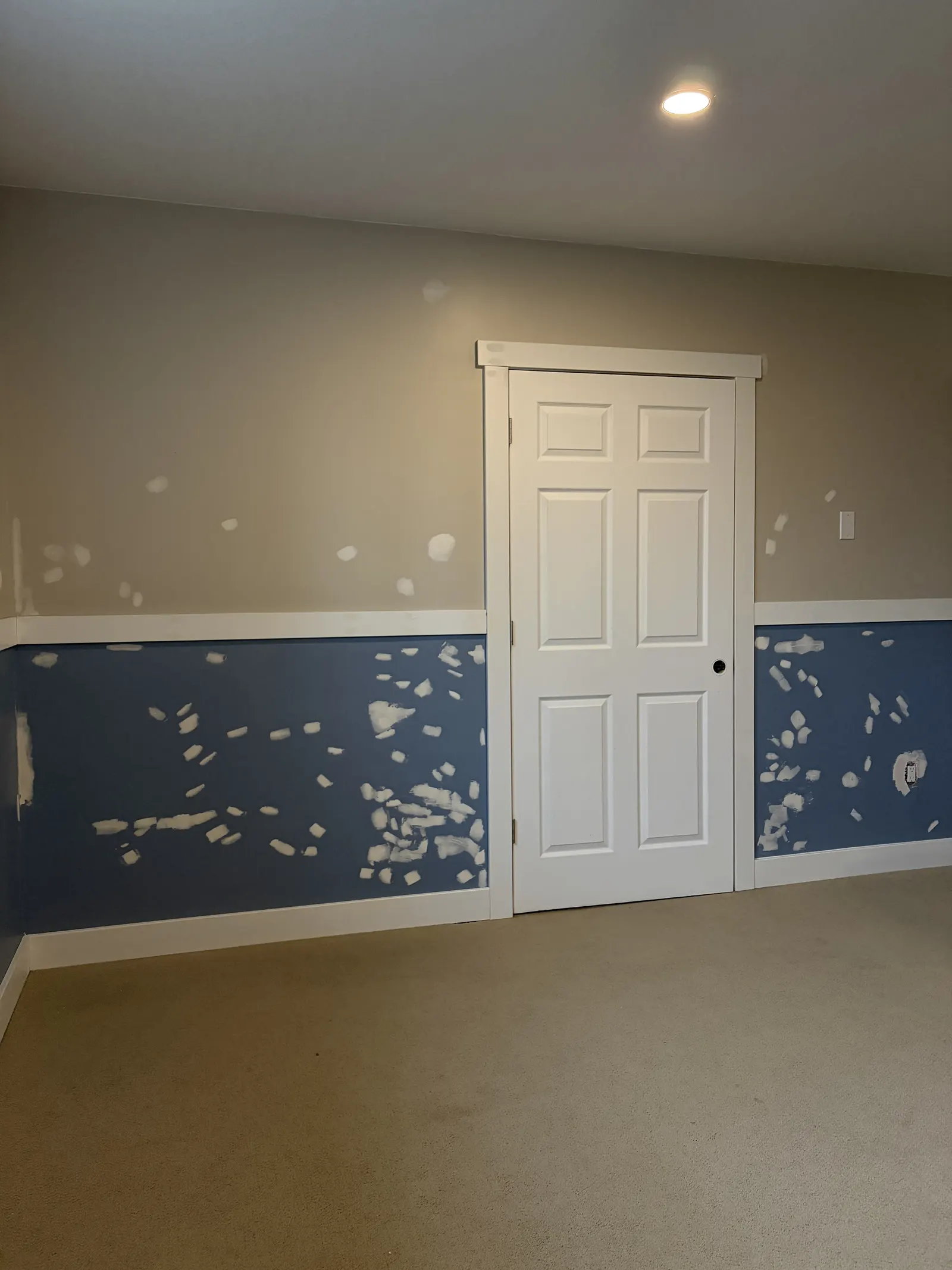 Basement wall with patched filler spots before painting by Paint Pure