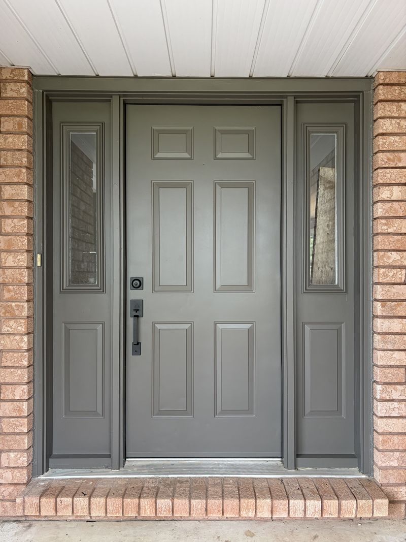 Freshly painted grey front entry door with glass sidelights by Paint Pure in Oxford County